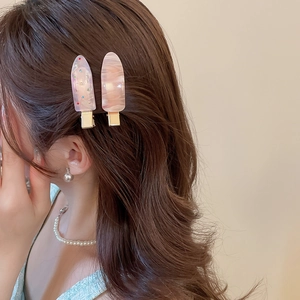Detail of pink candy-colored drop hair clips with glitter and marble texture