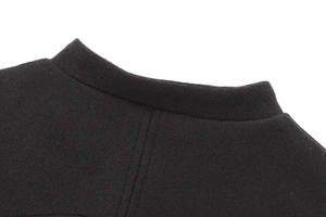 Close-up of black bomber jacket collar showing premium knit texture and precise stitching