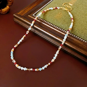 Colorful beaded necklace with natural stone and crystals on vintage leather background