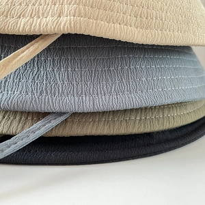 Macro view of water ripple texture and fine stitching on colorful cotton sun hats