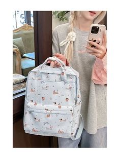 Detail of light blue graffiti backpack with dachshund patterns and top handles