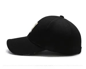 Detailed side view of black baseball cap featuring Vetements lettering on the brim edge