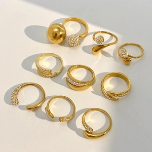Set of nine 18k gold plated stainless steel rings with sparkling white rhinestones
