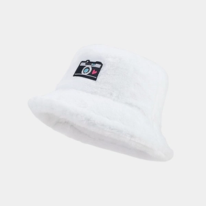 Detailed view of plush white bucket hat fabric with embroidered camera and heart patch