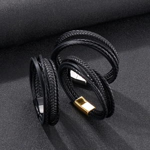 Detail of multi-layer braided leather bracelets with gold and silver magnetic clasps