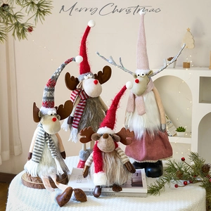 Set of four Nordic Christmas reindeer figurines with knitted hats and striped scarves