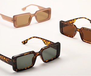 Close-up of retro square thick frame sunglasses in tortoiseshell and amber brown finishes
