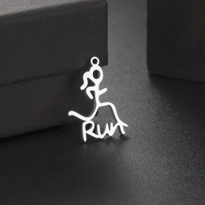 Polished stainless steel Run pendant with runner silhouette on dark textured background