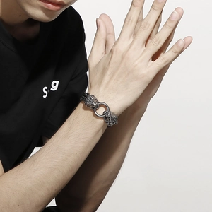 Detailed view of men's vintage lion head link bracelet in polished stainless steel finish
