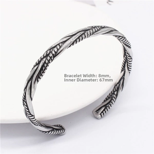 Close-up of retro 8mm titanium steel cuff bracelet with twisted weave texture