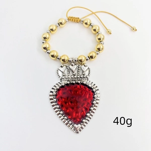 Detail of beaded bracelet with red heart pendant and crown charm weighing 40g