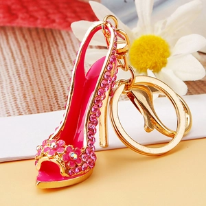 Macro shot of rose pink rhinestone high heel keychain with gold metal plating