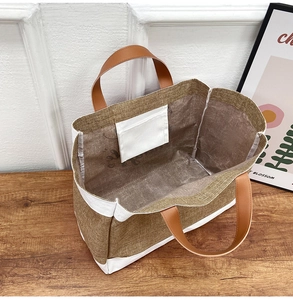 Top view of spacious jute tote bag interior showing inner pocket and PU leather handles