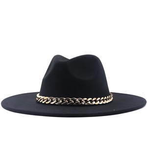 Detail of a black wool fedora hat featuring a chunky gold metal chain embellishment