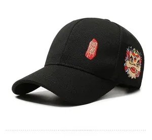 Detail of Chinese lion embroidery and red seal character on black cotton baseball cap
