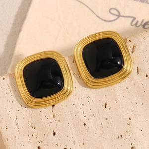 Detail of vintage 18K gold plated square stud earrings with black stone on stone base