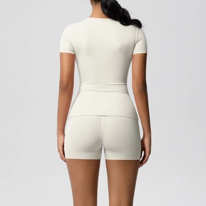 Rear view detail of off-white athletic yoga set featuring slim fit top and high waist shorts