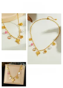 Detail of gold-plated necklace featuring heart, rose, and pearl multi-element charms
