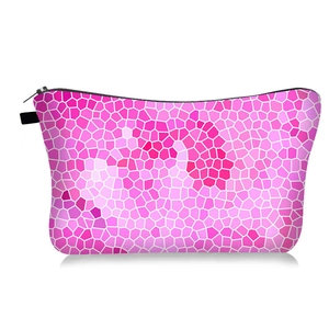 Close-up of geometric mosaic pattern and black zipper on pink hexagon makeup bag