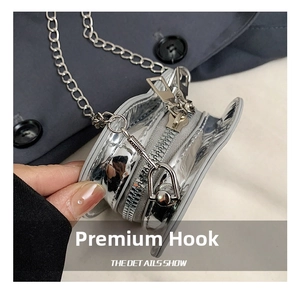 Detailed macro view of the silver metallic swivel hook and zipper on a mini bag