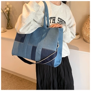 Lifestyle shot of large denim patchwork tote bag with wide strap and spacious interior