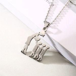 Detailed view of silver hollow mother and children pendant on a minimalist necklace