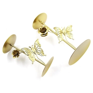 Golden iron candle holder with delicate butterfly and rose ornaments on white background