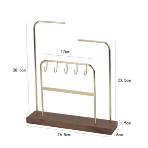 Detail of jewelry organizer with gold metal hooks and walnut base with dimensions
