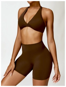 Detail of chocolate brown two-piece yoga set with twisted V-neck bra and high waist shorts