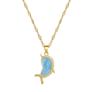 Luxurious gold narwhal pendant necklace with light blue enamel and sparkling crystals