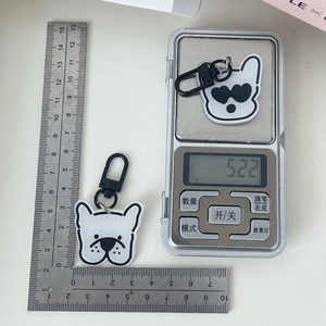 Macro view of French Bulldog acrylic keychain showing size scale and 5.22g weight