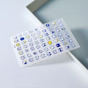Macro view of 5D adhesive nail stickers with cute blue and white cat facial expressions