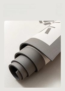 Close-up of flexible grey bath mat showing soft texture and rollable storage feature