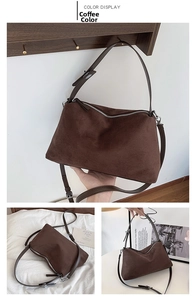 Detail view of coffee-colored suede underarm bag with silver zipper and fine stitching