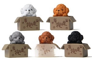 Macro detail of five resin puppy figurines in miniature cardboard boxes on white background