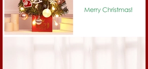 Close-up of lighted mini Christmas tree with red gift base and decorative ornaments