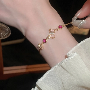 Bracelet papillon ajustable plaqué or avec pierres de zircone sur le poignet d'une femme
