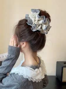 Detail of checkered and lace scrunchie styled on a bun for an elegant Korean look