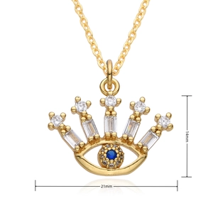 Macro shot showing dimensions 14mm by 21mm of the 18K gold evil eye crown pendant