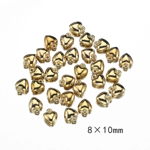 Macro shot of 8x10mm gold heart beads for DIY jewelry making with metallic finish