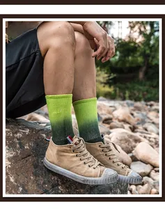 Close-up of green gradient cotton socks with Aurora embroidery and khaki canvas shoes