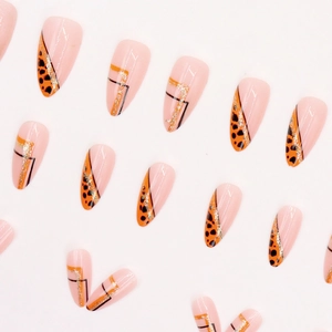 Almond press-on nails with leopard print, black geometric lines and gold glitter accents
