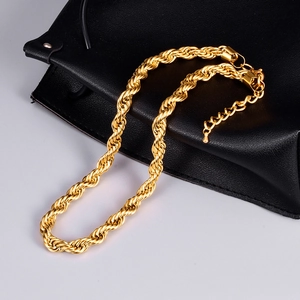 Detailed close-up of golden rope chain necklace with lobster clasp and adjustable tail