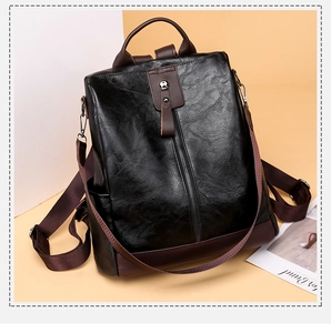 Detail of vintage faux leather backpack with contrast stitching and metal zipper accent