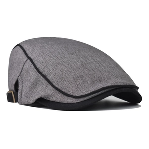Detail of grey ivy cap showing fabric texture, black stitched brim, and adjustable metal buckle