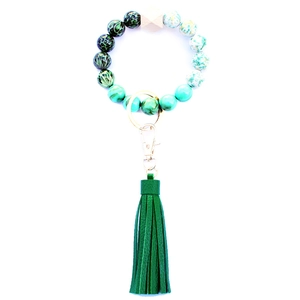 Detail of green leopard print and marble beads with a leather tassel keychain