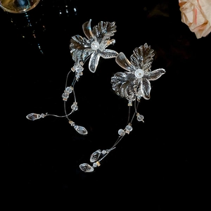 Detail of elegant clear flower earrings with long crystal tassels and hanging beads