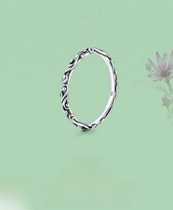 Macro detail of vintage S925 sterling silver ring with engraved vine texture