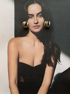 Close-up of model wearing chunky gold and silver two-tone C-hoop earrings in style