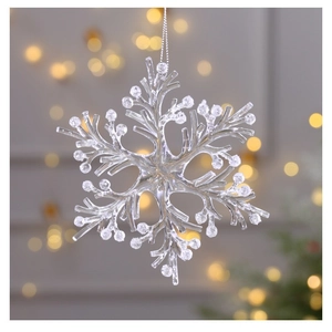 Close-up of a clear acrylic snowflake ornament with frosted white tips and hanging string